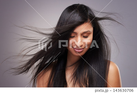 Hair care, wind and woman in studio with eyes closed for keratin treatment, shampoo or cosmetics on gray background. Hairstyle, body and model with beauty for satisfaction, growth or collagen shine Hair care, wind and woman in studio with eyes closed for keratin treatment, shampoo or cosmetics on gray background. Hairstyle, body and model with beauty for satisfaction, growth or collagen shine 143630706