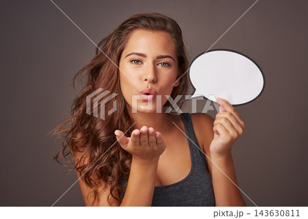 Speech bubble, blowing kiss and portrait of woman in studio for news, flirting and feedback. Mockup space, social media and person with sign for information, announcement and emoji on dark background Speech bubble, blowing kiss and portrait of woman in studio for news, flirting and feedback. Mockup space, social media and person with sign for information, announcement and emoji on dark background 143630811