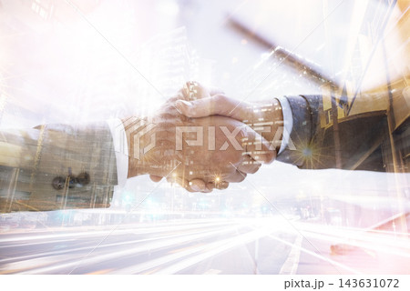 Business people, handshake and double exposure of city success with global networking or travel opportunity. Corporate worker or clients shaking hands with night deal or introduction in urban overlay 143631072