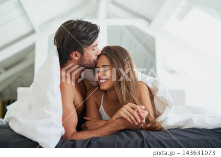 Couple, forehead kiss and embrace in bed for morning romance, love and bonding on weekend. Relationship, man and woman together in home for comfort, relax or support and resting in room with partner Couple, forehead kiss and embrace in bed for morning romance, love and bonding on weekend. Relationship, man and woman together in home for comfort, relax or support and resting in room with partner 143631073