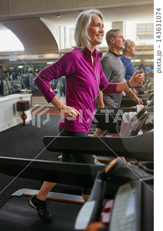 Sports, cardio and mature woman on treadmill in gym for health, wellness and body exercise. Smile, athletes and people on running equipment for endurance workout or training in fitness center 143631074
