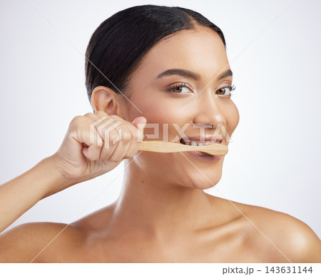 Dental, portrait or woman brushing teeth in studio for wellness, fresh breath or oral care on white background. Teeth whitening, face or model with eco friendly bamboo toothbrush for mouth cleaning Dental, portrait or woman brushing teeth in studio for wellness, fresh breath or oral care on white background. Teeth whitening, face or model with eco friendly bamboo toothbrush for mouth cleaning 143631144