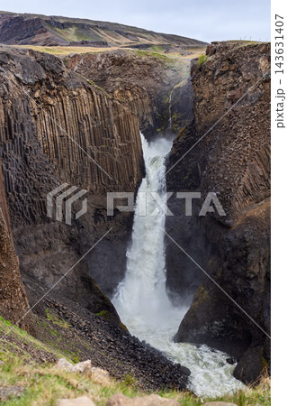 Litlanesfoss waterfall between basalt columns in a rugged gorge in East Iceland Litlanesfoss waterfall between basalt columns in a rugged gorge in East Iceland 143631407