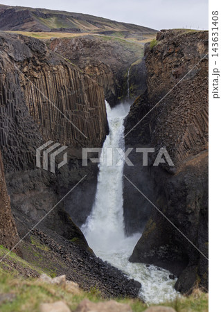 Litlanesfoss waterfall plunging between basalt columns in East Iceland in summer 143631408