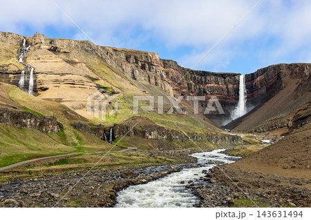 Hengifoss waterfall and Hengifossa rapids beneath red basalt cliffs in Iceland 143631494