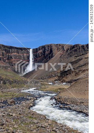 Hengifoss and Hengifossa river rapids in a sunlit summer valley in East Iceland 143631509