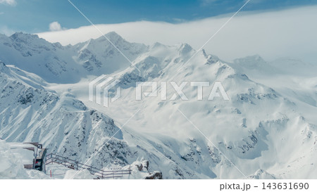 Snow-covered Caucasus mountain peaks and glacial valley with observation platform in foreground 143631690