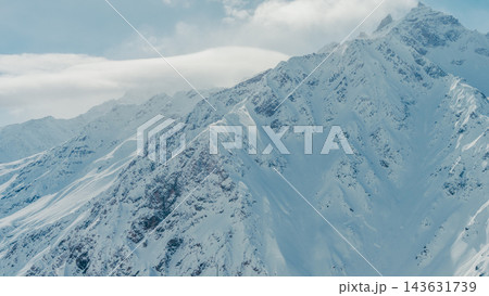 Mount Elbrus snow-covered rugged peaks in Caucasus Mountains panorama under soft daylight, aerial view, winter alpine landscape,sc Mount Elbrus snow-covered rugged peaks in Caucasus Mountains panorama under soft daylight, aerial view, winter alpine landscape,sc 143631739