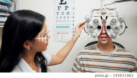 Doctor, ophthalmologist and man on phoropter for eye care, consultation and healthcare exam in clinic. Optometry, test and patient on lens machine for vision check, wellness and eyesight correction Doctor, ophthalmologist and man on phoropter for eye care, consultation and healthcare exam in clinic. Optometry, test and patient on lens machine for vision check, wellness and eyesight correction 143631862