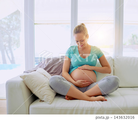 Relaxing, smile and pregnant woman on sofa in home holding belly for maternity care with happiness. Love, rest and maternal female person with stomach from Australia in living room at apartment. 143632016