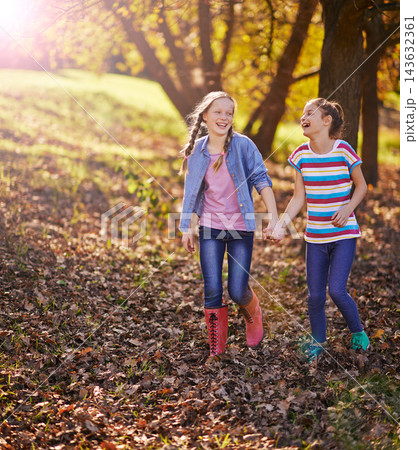 Holding hands, smile or children of friends in nature walking on adventure together in Autumn. Happy, fun or girl kids exploring in outdoor park, field or garden for bonding on weekend trip in Canada 143632361