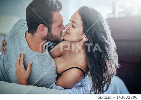 Passion, embrace and couple in bed with kiss, romance and morning bonding in apartment. Relationship, man and woman in bedroom with intimate affection, love and relax with care on weekend in home 143632800