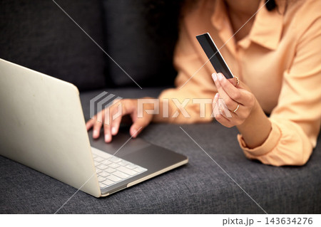Home, laptop and woman with credit card, hands or savings with investment, typing or payment. Person, closeup or girl with pc, paying for goods and online shopping with ecommerce, banking or internet 143634276
