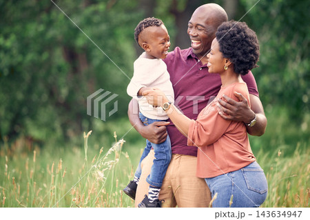 Black family, hug and laugh in field for bonding, affection and support in outdoor nature to connect. Parents, son and embrace for security in relationship, travel and funny conversation on vacation Black family, hug and laugh in field for bonding, affection and support in outdoor nature to connect. Parents, son and embrace for security in relationship, travel and funny conversation on vacation 143634947