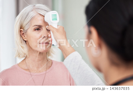 Senior, woman and nurse for forehead temperature, digital thermometer and health and medical appointment. Measure, fever and wellness clinic with professional in serious examination and equipment Senior, woman and nurse for forehead temperature, digital thermometer and health and medical appointment. Measure, fever and wellness clinic with professional in serious examination and equipment 143637035