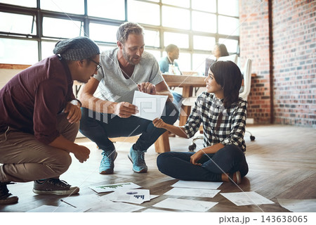 Meeting, discussion and business people with paperwork in office for growth, graphs or statistics. Project management, diversity and employees on floor for collaboration, planning or budget review 143638065