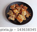 Fried fish nuggets on a black plate, offering a crispy and golden-brown seafood appetizer or snack, representing home cooking and delicious finger food 143638345