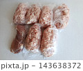 Various portions of raw minced pork and beef in clear plastic bags, prepared for freezing and bulk storage, facilitating meal preparation and efficient food management 143638372