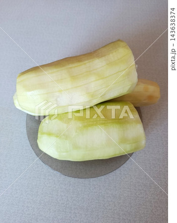 Peeled zucchini or squash vegetables showing raw ingredients ready for cooking, preparing healthy organic food in a kitchen environment Peeled zucchini or squash vegetables showing raw ingredients ready for cooking, preparing healthy organic food in a kitchen environment 143638374