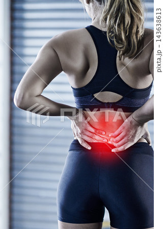 Woman, fitness and back pain with injury or red glow for accident or bruise after workout or exercise at gym. Rear view of female person with sore spine, ache or inflammation for hurt joint or muscle 143638613
