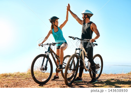 Outdoor, couple and high five in mountain bike by nature for celebration, achievement and training goal. Happy people, man and woman with bicycle for fitness, workout and sports success in Germany 143638930