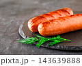 grilled sausages on slate stone, selective focus 143639888