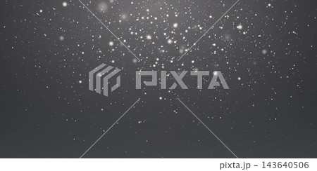 White particles falling on a dark background creating a shimmering light effect 143640506