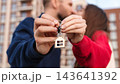 Closeup Couple Kissing And Holding Keys With House Keychain Outside Apartment Building. First Home Purchase, Mortgage, Homeownership And Shared Achievement Concept. 143641392