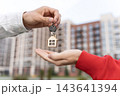 Closeup Of Woman Receiving Keys With House Keychain Outside Apartment Building. Mortgage Financing, Home Loan And Becoming A Homeowner Concept.  143641394