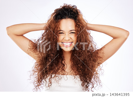 Portrait, woman and hair care by white background for cosmetic, growth and beauty or glow in studio. Happy, face and gen z female person with smile for keratin treatment, curl or frizz transformation Portrait, woman and hair care by white background for cosmetic, growth and beauty or glow in studio. Happy, face and gen z female person with smile for keratin treatment, curl or frizz transformation 143641395