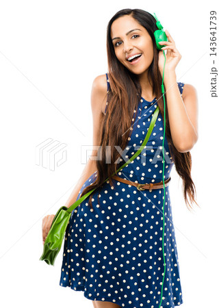 Fashion, music and portrait of woman in dress isolated on studio white background for streaming or style. Audio, sound or trendy with happy model listening to song on radio in casual clothes outfit 143641739