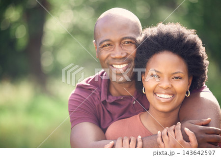 Black couple, hug and love in field for portrait, affection and support in outdoor nature to connect. People, marriage and embrace for security in relationship, travel and care on vacation in woods 143642597