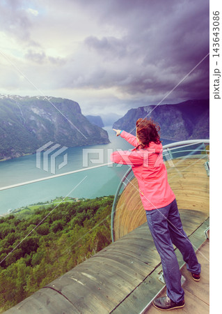 Tourist on Stegastein viewpoint, Norway 143643086