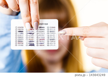 Woman holding codes for online transfers 143643249
