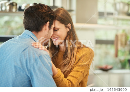 Love, bonding and couple hugging in kitchen in morning for greeting, support and care at home. Happy, romance and young man and woman embracing for sweet moment together at modern apartment in Canada 143643990
