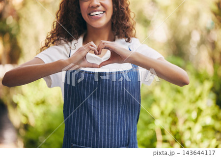 Woman, heart hands and smile in garden for small business with love, sign or symbol for choice with plants. Entrepreneur, happy and outdoor with icon, emoji and feedback with sustainability at shop Woman, heart hands and smile in garden for small business with love, sign or symbol for choice with plants. Entrepreneur, happy and outdoor with icon, emoji and feedback with sustainability at shop 143644117