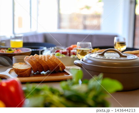 キッチンでパンを切り分ける料理風景 キッチンでパンを切り分ける料理風景 143644213