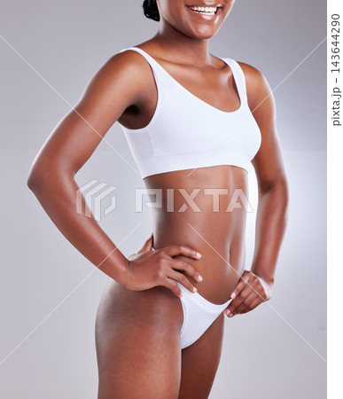 Woman stomach, body and fitness underwear for wellness, body care and gut health in studio. Abdomen of happy model with weight loss, exercise or workout results or confidence on a white background 143644290