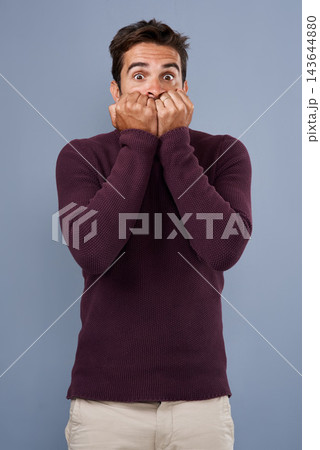 Portrait, afraid and phobia of man in studio, anxiety and biting of nails for stress, scared and fear. Blue background, mockup space and person with terror for nightmare of fail in test of college Portrait, afraid and phobia of man in studio, anxiety and biting of nails for stress, scared and fear. Blue background, mockup space and person with terror for nightmare of fail in test of college 143644880