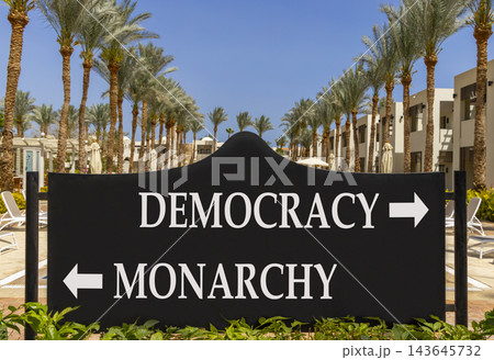 Democracy or monarchy words symbol. Concept words Democracy Monarchy on beautiful black road sign. Beautiful palm trees background. Business democracy monarchy concept. Copy space 143645732