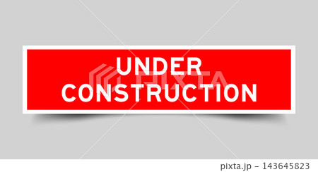 Red color square shape sticker label with word under construction on gray background 143645823