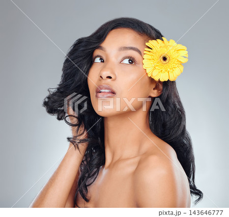 Woman, flower and thinking with natural beauty for texture or collagen on a white studio background. Face of female person, brunette or young model in wonder with glow, shine or bloom for treatment 143646777