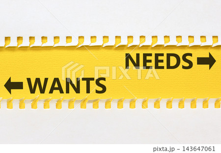 Needs instead wants words symbol. Concept words Needs Wants on beautiful yellow paper. Beautiful white background. Business psychology needs or wants concept. Copy space. Needs instead wants words symbol. Concept words Needs Wants on beautiful yellow paper. Beautiful white background. Business psychology needs or wants concept. Copy space. 143647061