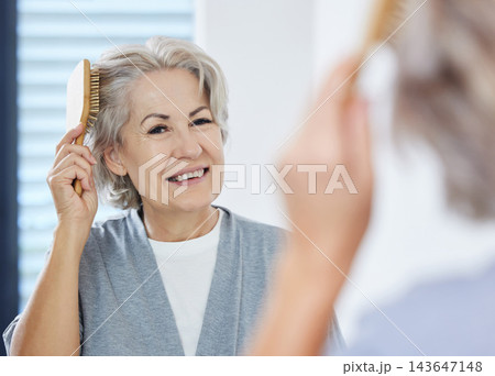 Home, senior woman and comb hair in mirror for maintenance, texture and growth in bathroom. House, reflection and elderly person with hairbrush for scalp health, wellness and self care in retirement Home, senior woman and comb hair in mirror for maintenance, texture and growth in bathroom. House, reflection and elderly person with hairbrush for scalp health, wellness and self care in retirement 143647148