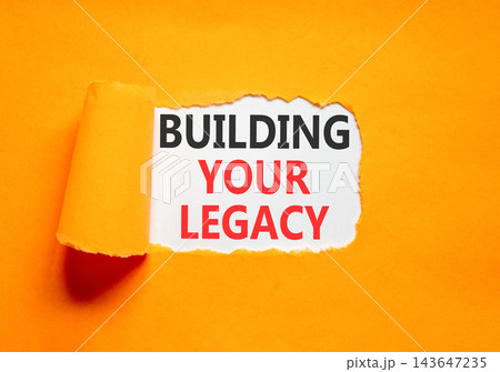 Building your legacy words symbol. Concept words Building your legacy on beautiful white paper. Beautiful orange background. Business building your legacy concept. Copy space. Building your legacy words symbol. Concept words Building your legacy on beautiful white paper. Beautiful orange background. Business building your legacy concept. Copy space. 143647235