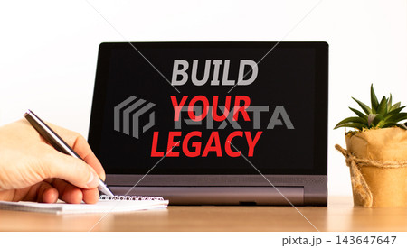 Build your legacy words symbol. Concept words Build your legacy on beautiful black tablet. Beautiful white background. Businessman hand. Business build your legacy concept. Copy space. Build your legacy words symbol. Concept words Build your legacy on beautiful black tablet. Beautiful white background. Businessman hand. Business build your legacy concept. Copy space. 143647647