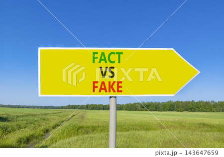 Fact vs versus fake words symbol. Concept words Fact vs Fake on beautiful yellow road sign. Beautiful blue sky green grass background. Business and fact vs versus fake concept. Copy space. 143647659