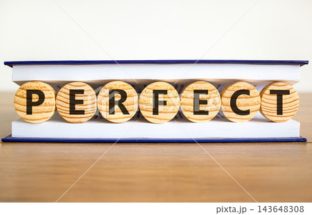 Perfect word symbol. Concept word Perfect on beautiful wooden circles in book. Beautiful wooden table white background. Business perfect word concept. Copy space. 143648308