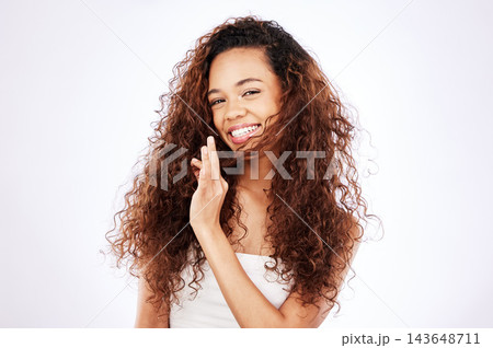 Girl, portrait and natural in studio for hair care, eco friendly and organic or sustainable cosmetics for scalp treatment. Brazilian woman, mock up and white background with healthy frizz and growth. Girl, portrait and natural in studio for hair care, eco friendly and organic or sustainable cosmetics for scalp treatment. Brazilian woman, mock up and white background with healthy frizz and growth. 143648711