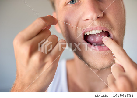 Self care, portrait and man flossing teeth in home for health, grooming and morning routine. Smile, oral hygiene and male person with dental product for fresh breath mouth treatment at apartment. Self care, portrait and man flossing teeth in home for health, grooming and morning routine. Smile, oral hygiene and male person with dental product for fresh breath mouth treatment at apartment. 143648882